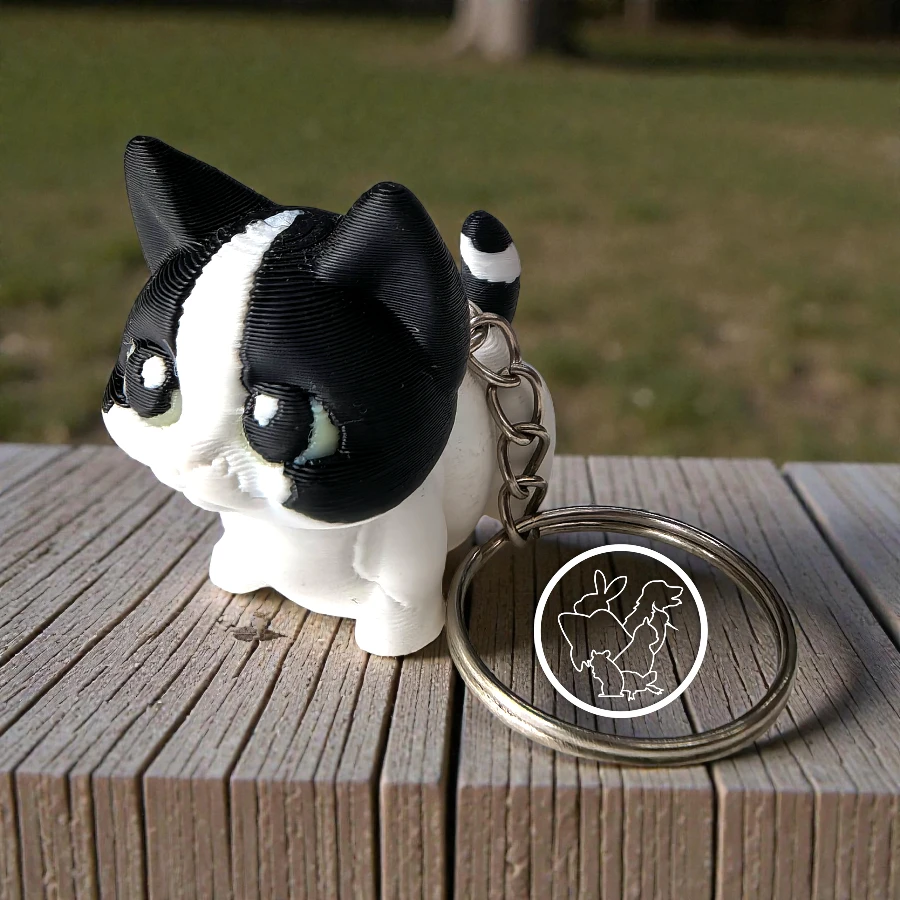 Llavero 3D de gato articulado blanco con negro